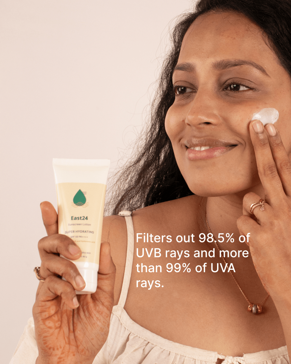 Woman applying East24 Super Hydrating SPF 50 PA++++ sunscreen in front.